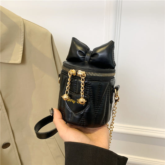 Mini sac à bandoulière cylindrique tendance et mignon avec fermeture éclair et nœud papillon de couleur unie