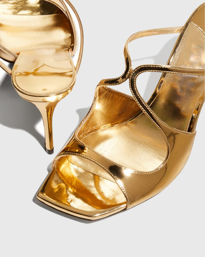 Elvia Metallic Cross Sandals In Gold