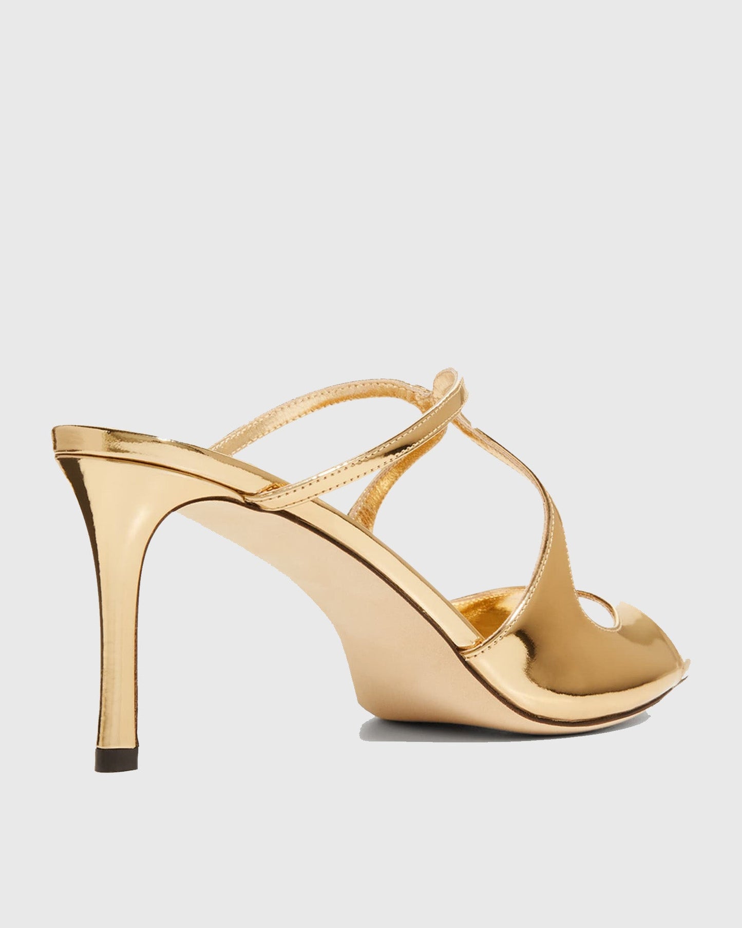 Elvia Metallic Cross Sandals In Gold