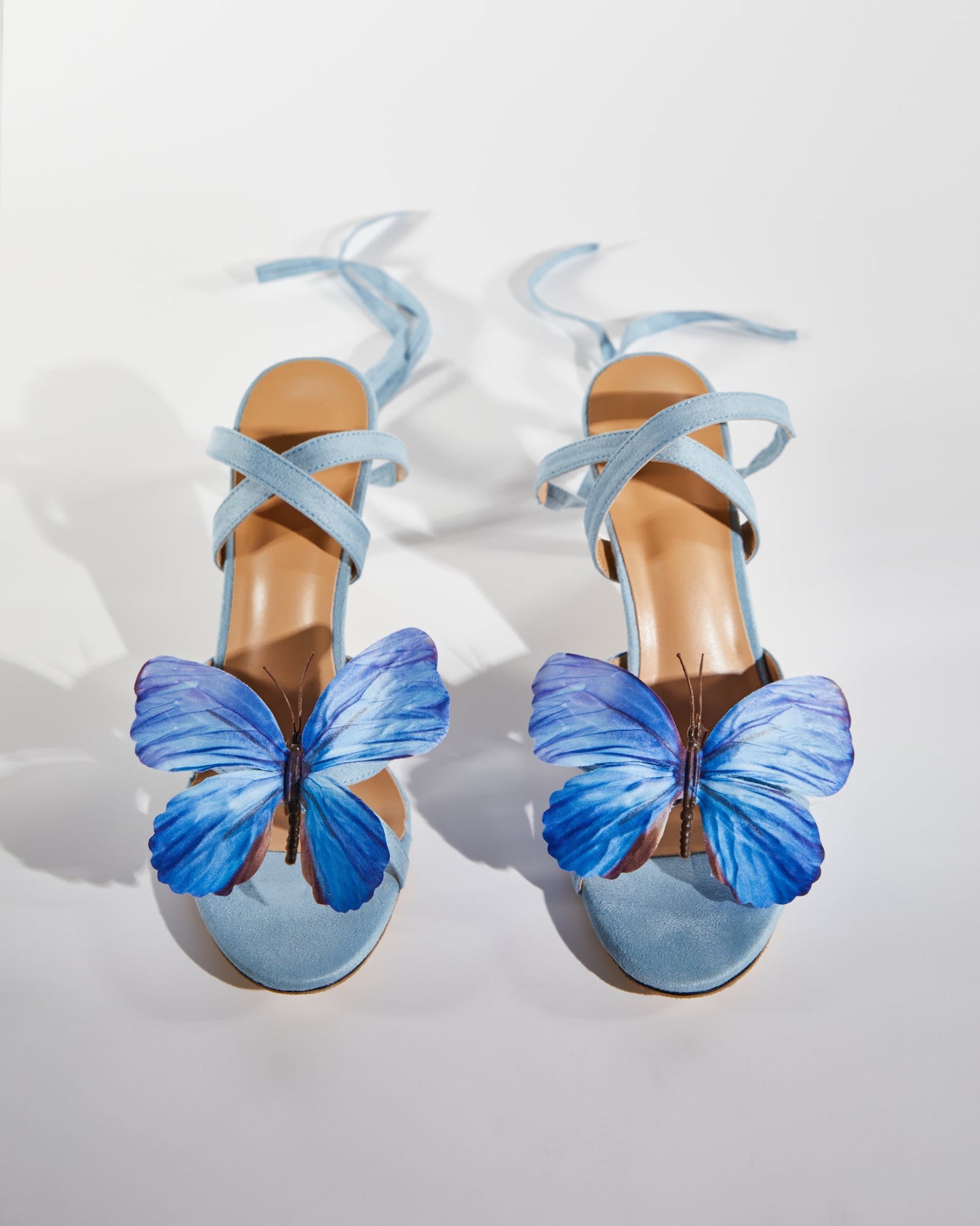 Io Butterfly Cross Strap Sandals In Blue