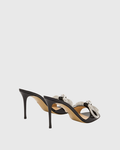 Rina Crystal Bow Patent Leather Mules In Black